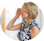 Woman Trying On Eyeglasses In Store